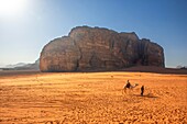 Tourists on a camel in the Wadi Rum desert Jordan