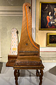 An original upright piano by Domenico del Mela in the Accademia Gallery in Florence, Italy. circa 1739. The soundboard cover is on the wall behind. This is probably the first piano ever built with this vertical design.