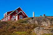 Inuit art sculpture and paint, colorfull houses in Tasiilaq, also known as Ammassalik, East Greenland, Greenland