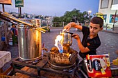 Tea and coffee street young vendor in Rainbow street fashion Jabal district in the First Circle, Amman Jordan. Rainbow Street, Jabal Amman, Amman, Jordan, Middle East