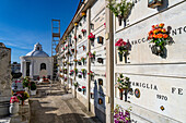 Flowers decorate the mausoleum niches in a cemetery in Anacapri on the island of Capri, Italy.