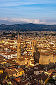 View of the towers of the Badia Fiorentina & Palazzo del Bargello seen from the Palazzo Vecchio tower in Florence, Italy. The shadow of the Palazzo Vecchio tower is projected onto the Palazzo del Bargello.