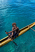 Residents of Tungelo Island in their traditional dugout canoes, New Ireland province, Papua New Guinea