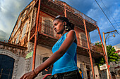 Girl and the colonial houses in the historic colonial old town, Jacmel city center, Haiti, West Indies, Caribbean, Central America