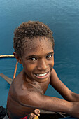 Residents of Tungelo Island in their traditional dugout canoes, New Ireland province, Papua New Guinea