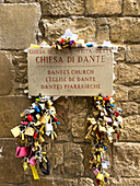 Lover's padlocks on facade of the Church of Saint Margaret of Antioch in Florence, Italy. It was the church of Dante Alighieri and the place where he first saw Beatrice Portinari.