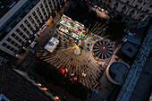 Aerial view of Christmas decoration and entertainment illuminated at night in El Pilar Square, Zaragoza, Spain