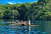 Residents of Vitu Islands in their traditional dugout canoes, Garove Island, Johann Albrecht Harbour, Papua New Guinea