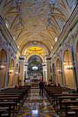 A parishoner collects offerings during mass in the Church of San Gennaro in Vettica Maggiore, Praiano, Italy.