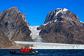 Tourists exploring the Thryms Glacier in zodiac, Skjoldungen Fjord, Southeast coast, Greenland