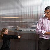 Girl Bossing Around Man in Office