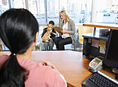 Boy and Woman with Dog at Veterinarian's Office