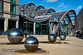 Steel Balls, with Winter Gardens behind, Millenium Square, Heart of the City, Sheffield, Yorkshire, England