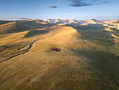 Vew of the Song Kol Lake area with yurts in foothills at sunrise, Kyrgyzstan