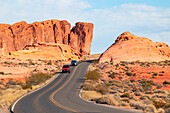 Two cars drive along the scenic road in Valley of Fire State Park on a sunny summer day, Nevada, United States of America