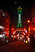 Night illumination of Shinsekai Tower in pitch black night, neon lights, Osaka, Honshu, Japan