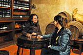 Young women tasting Madeira Wine in cellar of the Quinta do Furao, Santana, Madeira island, Atlantic Ocean, Portugal