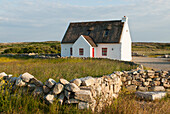 Cottage and low wall, Connemara, County Galway, Connacht, Republic of Ireland