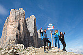 Hikers taking selfies at foot of Tre Cime di Lavaredo (Three Peaks of Lavaredo), Three Peaks Nature Park, Dolomites, UNESCO, South Tyrol, Italy