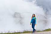 Hiker in mist near the refuge Lavaredo, Three Peaks Nature Park, Dolomites, South Tyrol (Alto Adige), Italy