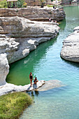 Two young girls bathing in the Wadi Bani Khalid, Hajar Mountains, Sultanate of Oman, Arabian Peninsula