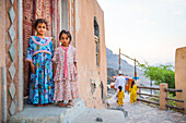 Two little girls, Mosque, Wakan village, Western Hajar Mountains, border South Batinah and Al Dakhiliyah Governorates, Oman, Arabian Peninsula