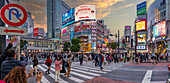 View of people at the world's busiest road crossing, Shibuya Scramble Crossing at sunset, Minato City, Tokyo, Honshu, Japan