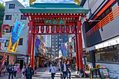 View of Torii gate, colourful shops and buildings in Asakusa, Taito City, Tokyo, Honshu, Japan