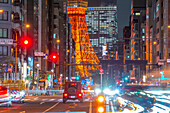 View of Tokyo Tower, city street and trail lights at night, Minato City, Tokyo, Honshu, Japan