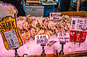 View of cold Sake on fish stall in Omicho Market, Kanazawa City, Ishikawa Prefecture, Honshu, Japan