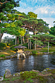 View of Japanese stone lantern and pagoda in Kenrokumachi Japanese Garden, Kanazawa City, Ishikawa Prefecture, Honshu, Japan