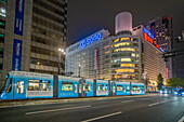 View of street scene, city tram and buildings in Hiroshima at night, Hiroshima, Honshu, Japan