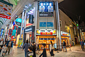 View of colourful shops and restaurants in shopping arcade at night, Hiroshima, Honshu, Japan