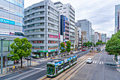 Elevated view of traffic and tram on major street during daytime, Hondori, Naka Ward, Hiroshima, Honshu, Japan