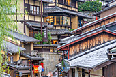 View of busy street and traditional wooden houses in Gion, Kyoto Geisha District, Kyoto, Honshu, Japan