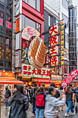 View of colourful facades of restaurants in Dotonbori, vibrant entertainment district near the river, Osaka, Honshu, Japan