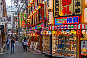 View of colourful facades of shops and restaurants in Dotonbori, vibrant entertainment district near the river, Osaka, Honshu, Japan