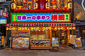 View of colourful facade of shop in Dotonbori, vibrant entertainment district near the river, Osaka, Honshu, Japan