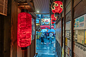 View of Japanese lanterns in dark alleyway in Dotonbori, vibrant entertainment district near the river, Osaka, Honshu, Japan