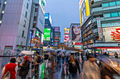 View of colourful adverts in Dotonbori, vibrant entertainment district near the river at dusk, Osaka, Honshu, Japan