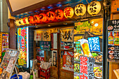 View of colourful signs in backstreet in Dotonbori, vibrant entertainment district near the river, Osaka, Honshu, Japan