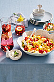 Ice-cold berry water, fruit salad with basil cream