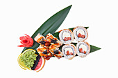 Free-standing plate of sushi rolls with salmon and cream cheese, garnished with teriyaki prawns