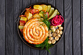 Fried sausage with potatoes, roasted bacon and side dishes