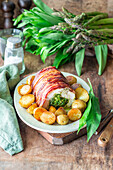 Turkey breast with wild garlic and asparagus stuffing wrapped in bacon
