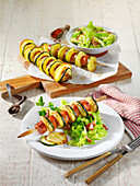 Sausage and potato skewers with warm savoy cabbage salad
