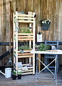 DIY garden shelf made from painted fruit crates with herbs and plants