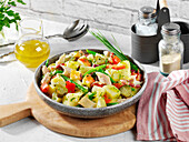 Fine potato salad with smoked trout, apple, bacon and beans