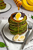 Banana and spinach pancakes with honey and yoghurt