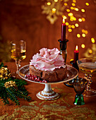 Festive cake with sugar flower, redcurrants and icing sugar